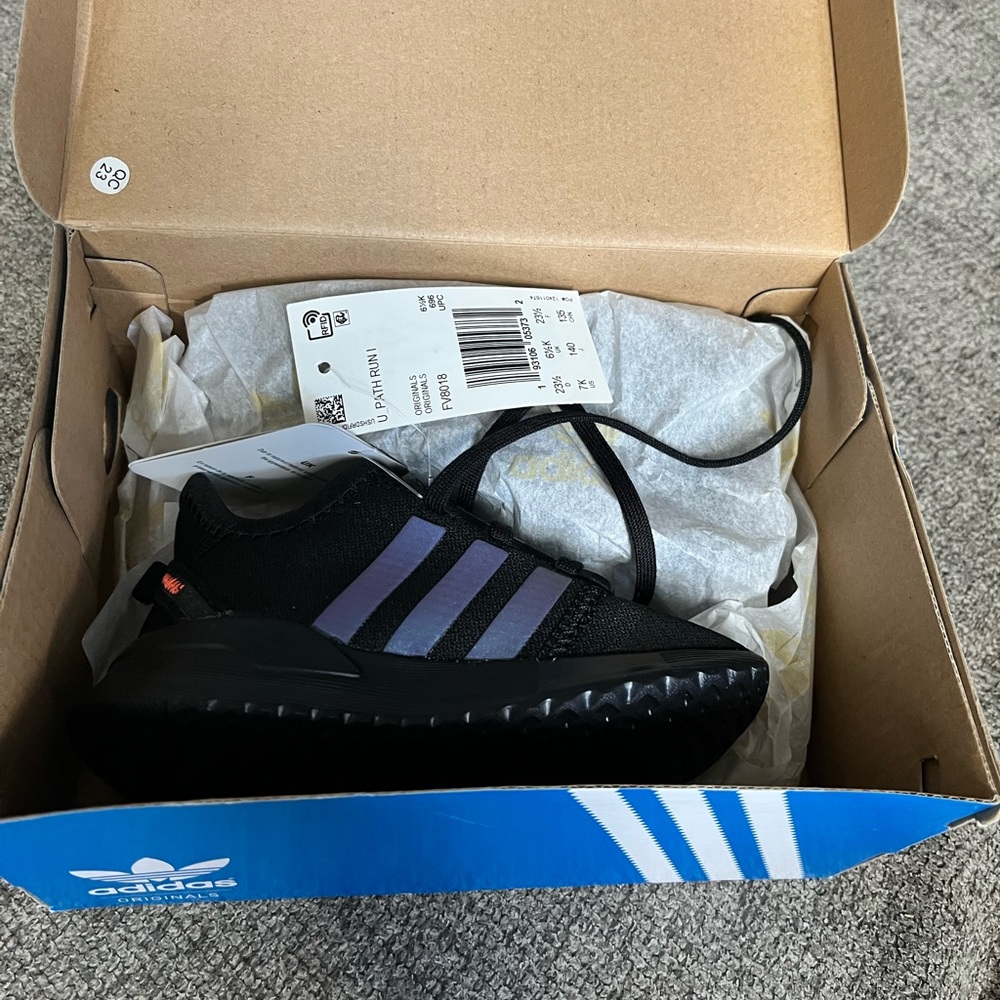 Brand new toddler black adidas with blue stripes.